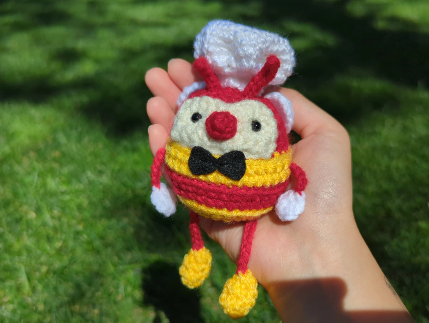 Crocheted soft toy of a cartoon bumblebee, dressed like the mascot of Filipino food chain, Jollibee.