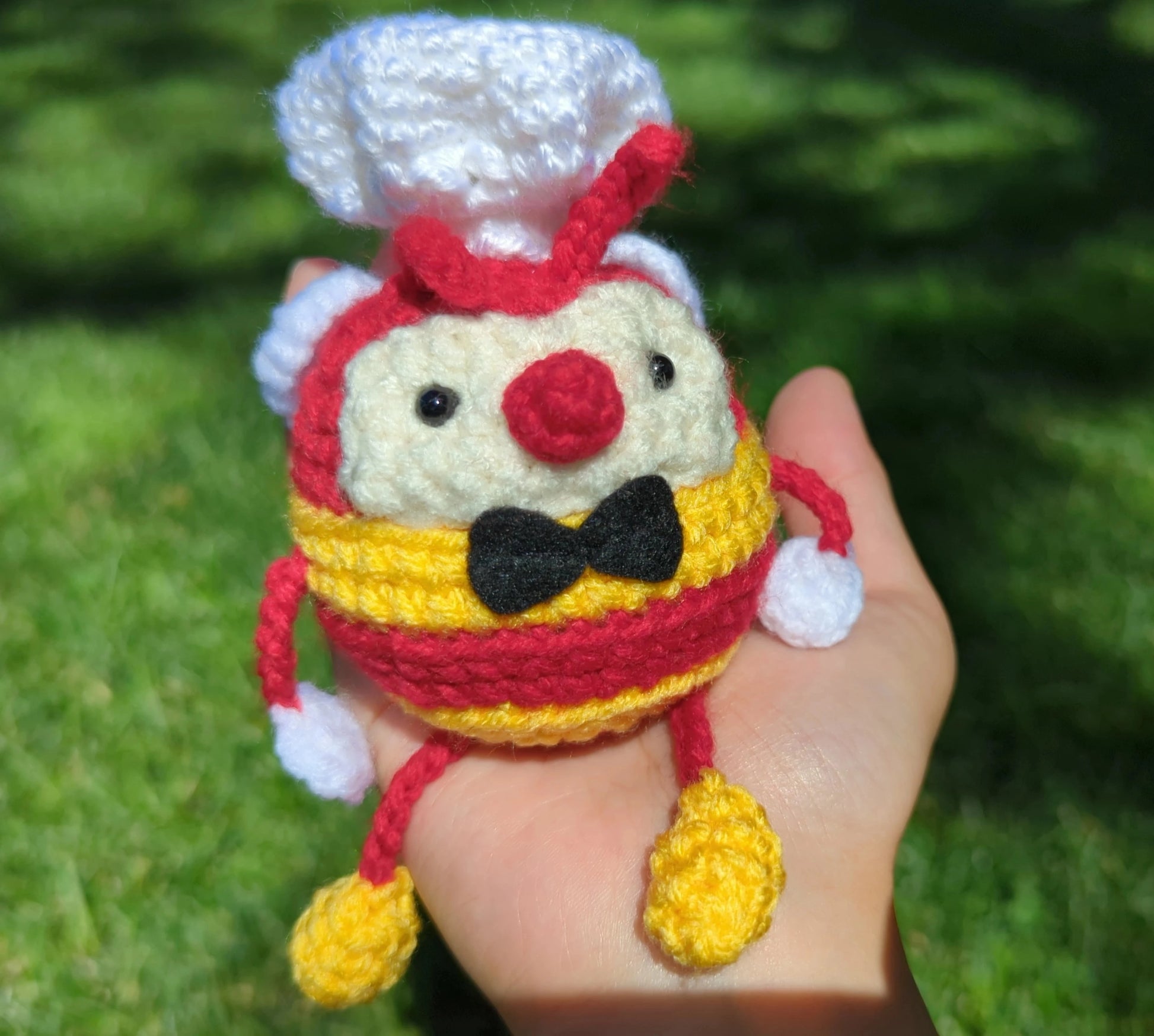 Crocheted soft toy of a cartoon bumblebee, dressed like the mascot of Filipino food chain, Jollibee.