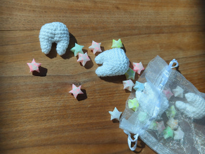 crocheted teeth and paper stars spilling out of an organza bag