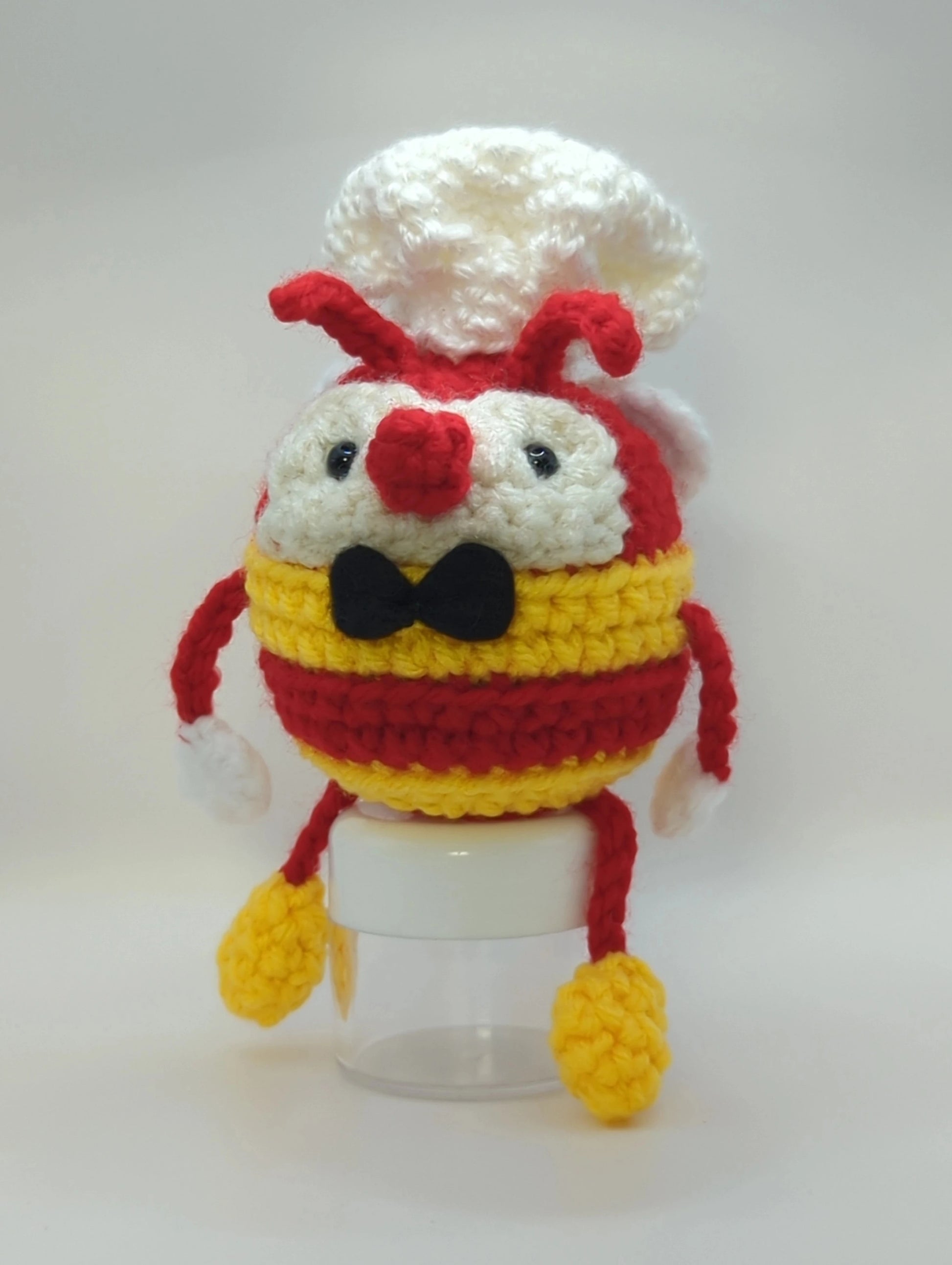 Crocheted soft toy of a cartoon bumblebee, dressed like the mascot of Filipino food chain, Jollibee.