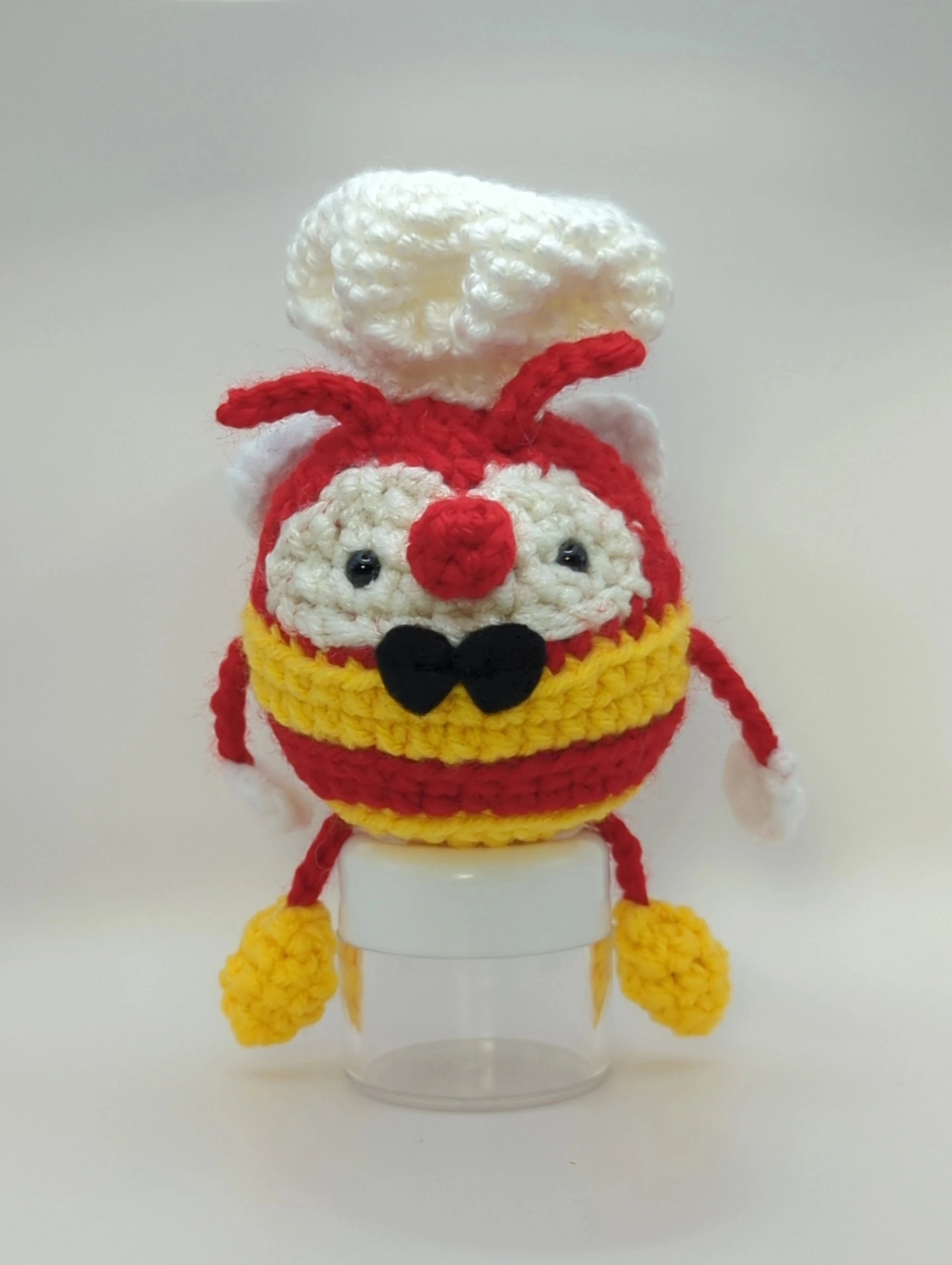 Crocheted soft toy of a bumble bee dressed like the mascot of popular Filipino food chain, Jollibee