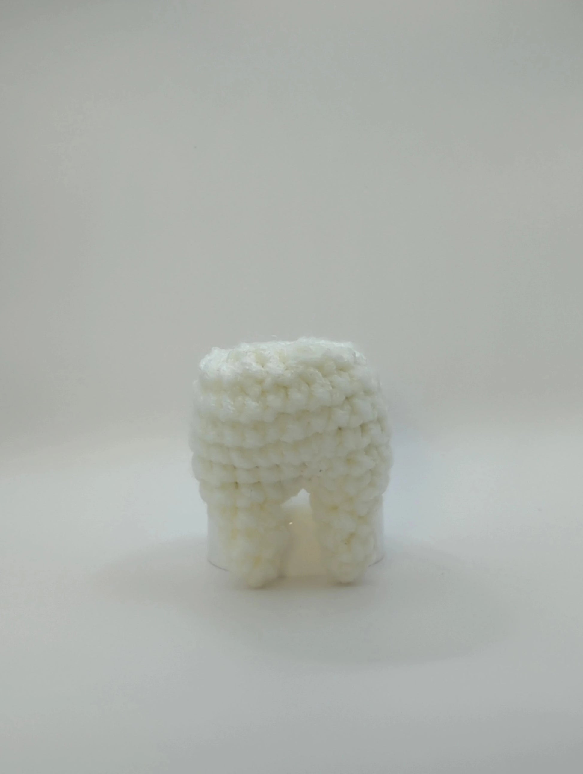 crocheted soft toy of a tooth